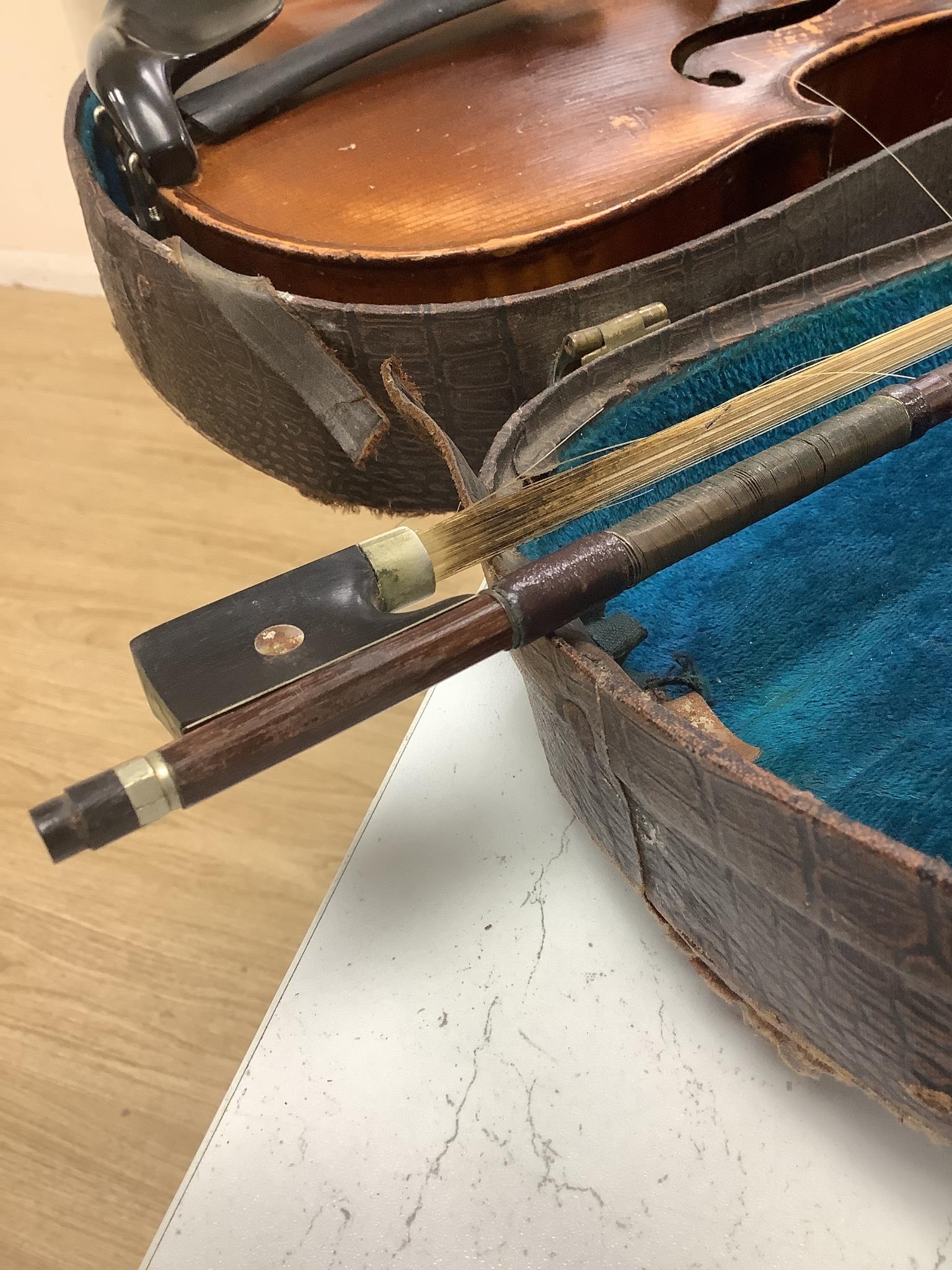 A cased violin, back 36cm, with bow